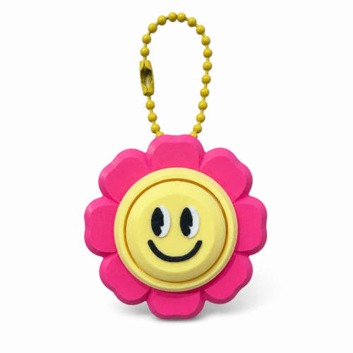 3D clicker sleutelhanger in de vorm van een lachende bloem in roze en geel